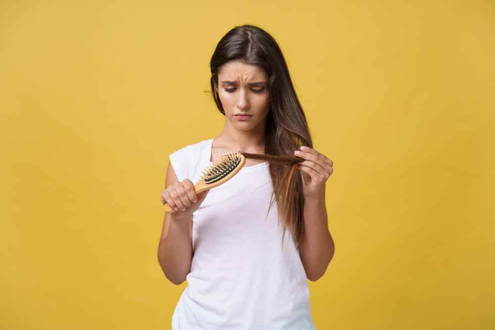 woman-hand-holding-her-long-hair-with-looking-damaged-splitting-ends-hair-care-problems(1)(1)